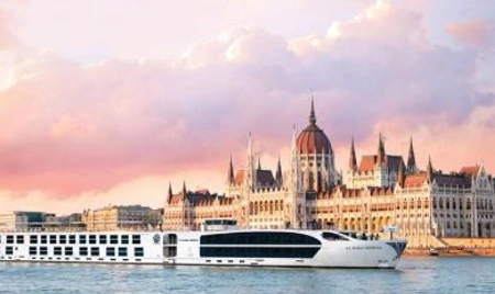 A river cruise beside the illuminated Budapest Parliament